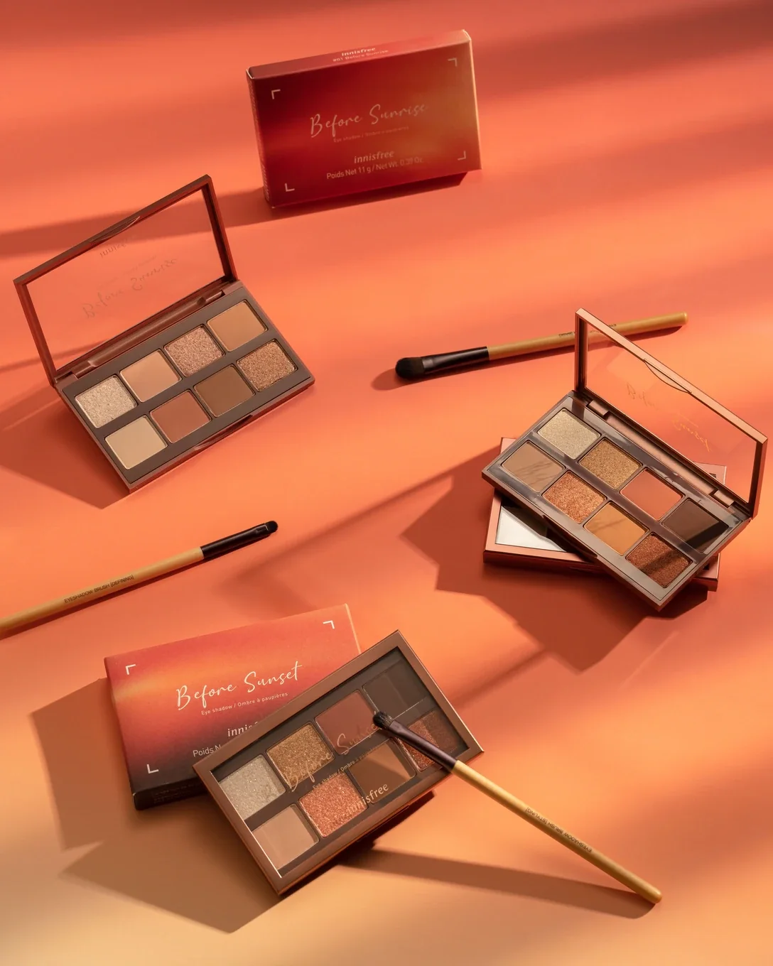 innisfree Before Sunrise and Before Sunset eyeshadow palettes on a warm orange backdrop